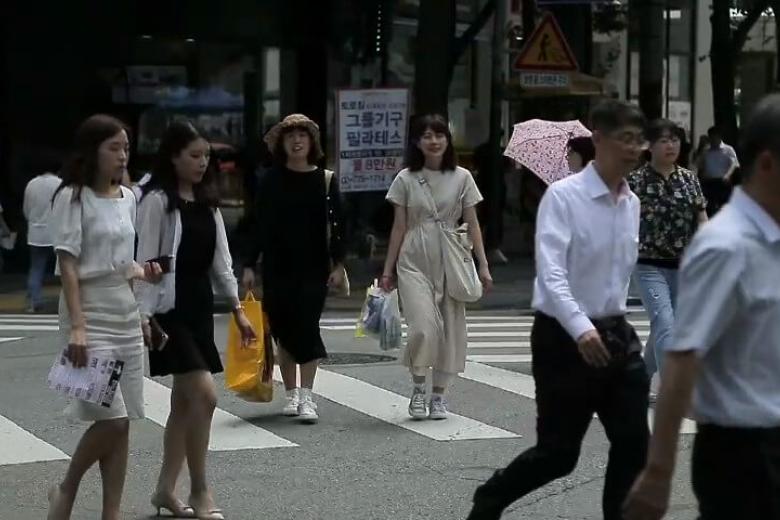 Four women crossing a street