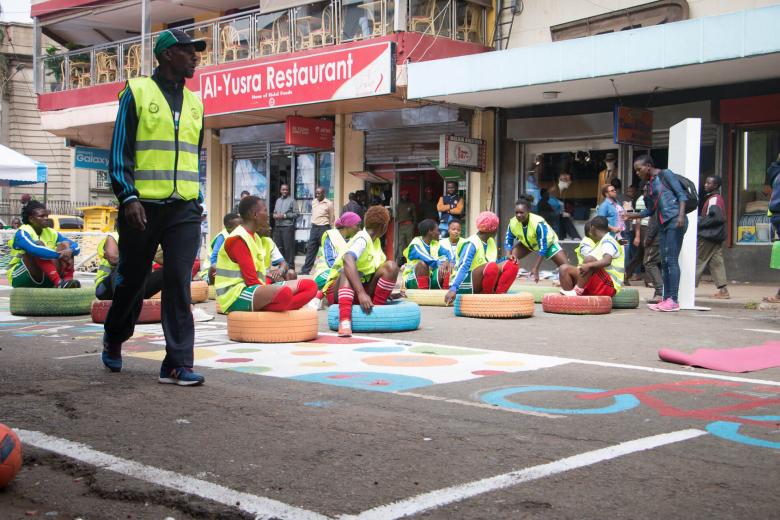Youth participating in placemaking on a colorful street